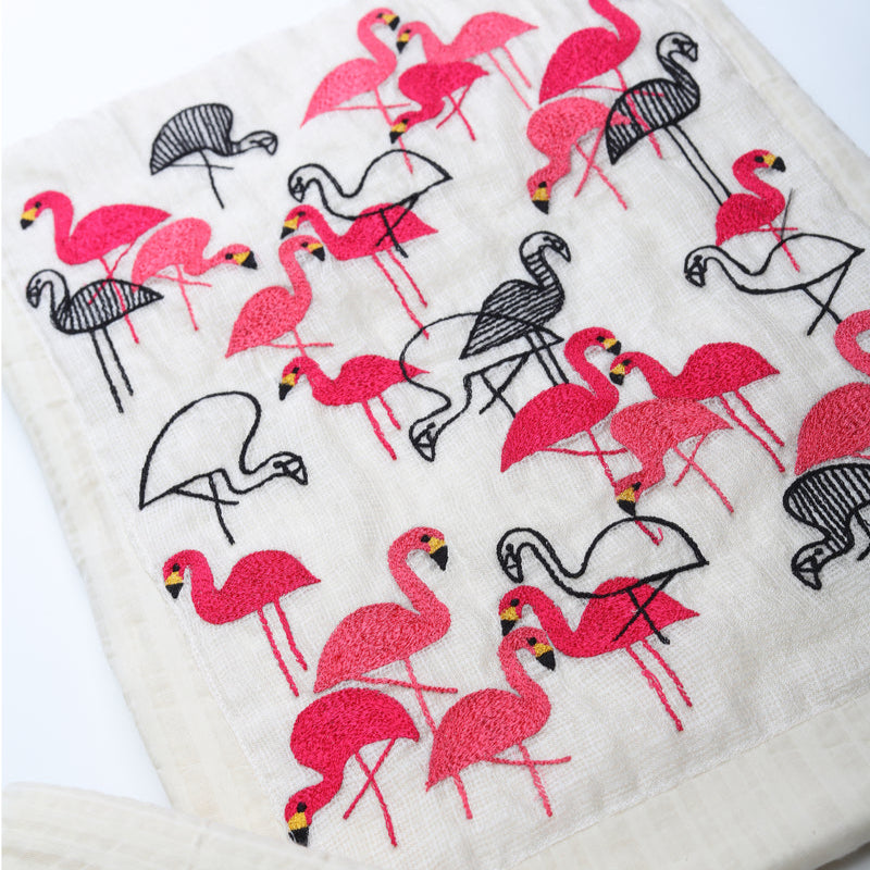 Floral-patterned fabric with pink and black flowers on a white background